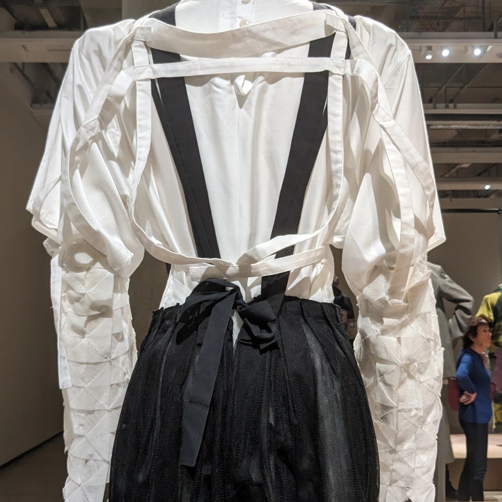 Pleats, bows, straps and cute sleeve detail